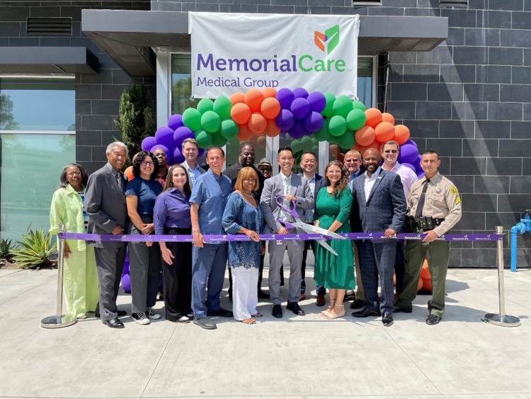 Various Carson government officials and executives pose in front of a MemorialCare Medical Group to cut a ribbon, symbolizing the grand opening of this new clinic. 