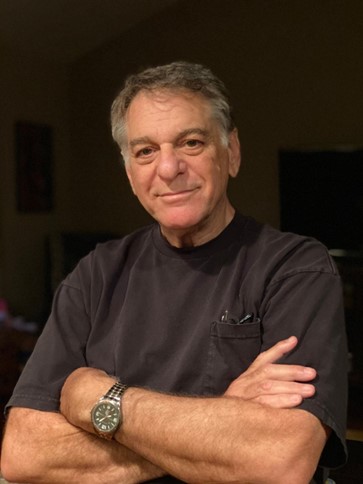 Mark suddock wearing a watch smiling for the camera.