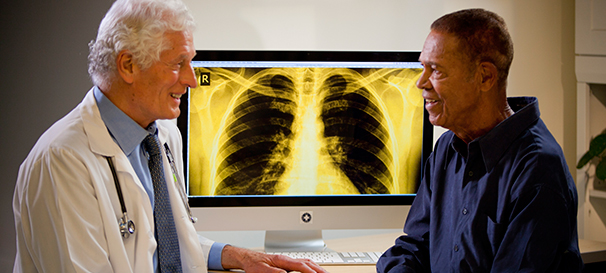 Photo of a physician sharing an X-ray with a patient