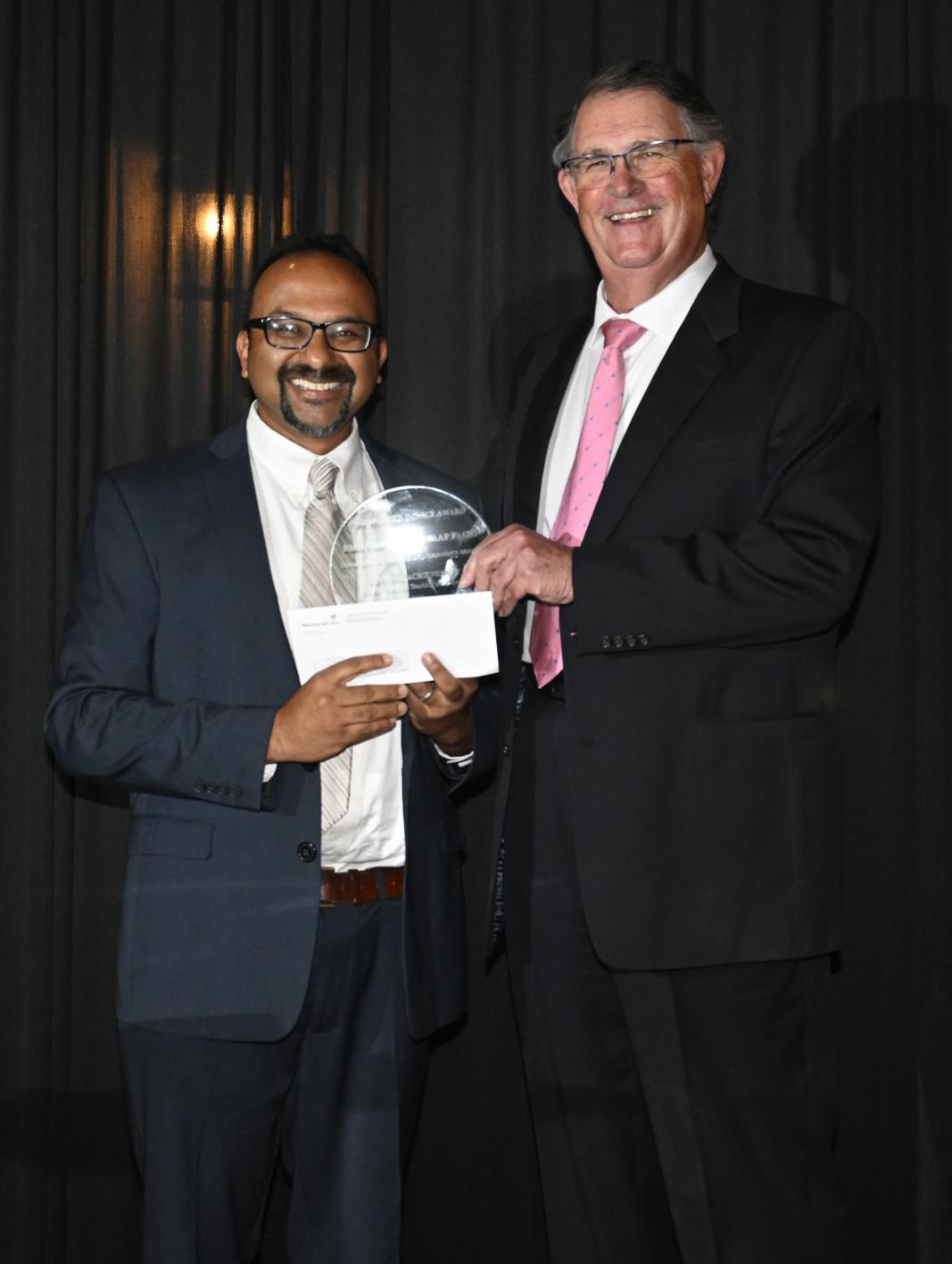 Dr. Rishi Bhargava receiving award.