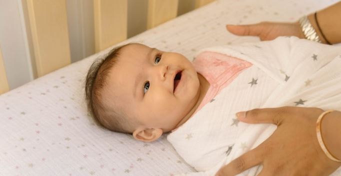 Image of a happy baby in a crib