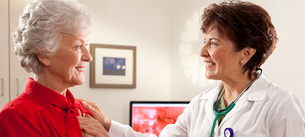 Image of a female doctor examining the heart of a female patient